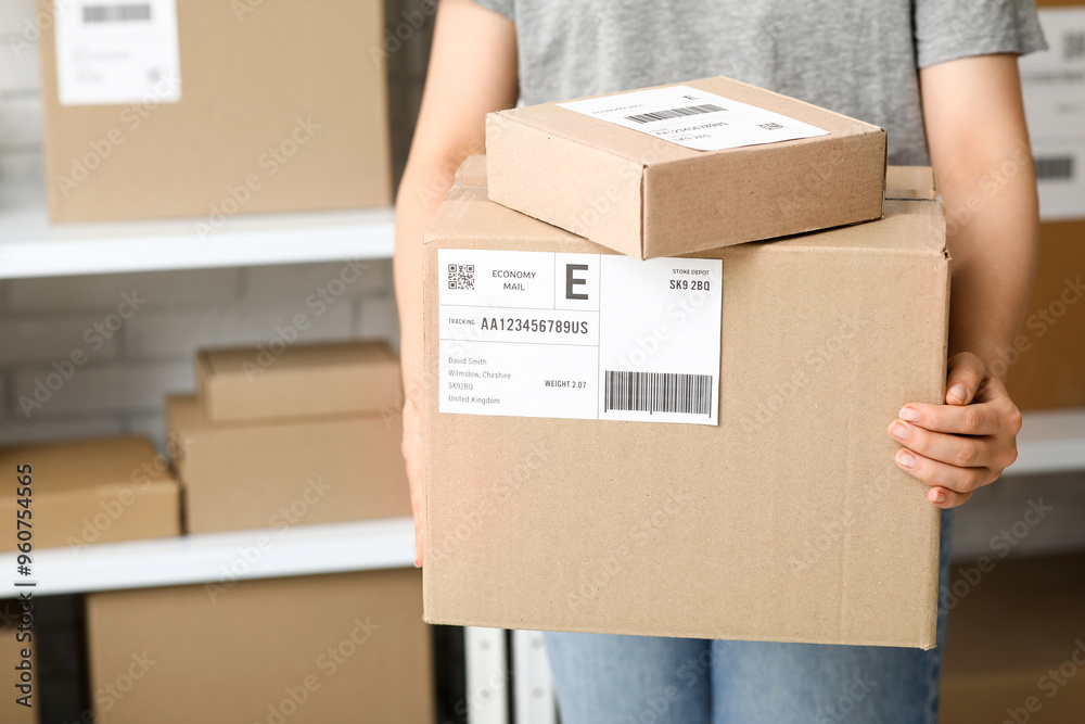 Sticker woman with parcel boxes at postal warehouse, closeup