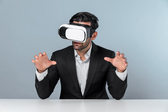 Smart businessman sitting while pointing and choosing data analysis by using technology innovation. Professional caucasian project manager using virtual reality glasses and VR goggles. Deviation.