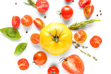 Different fresh tomatoes with basil, rosemary and peppercorn on white background