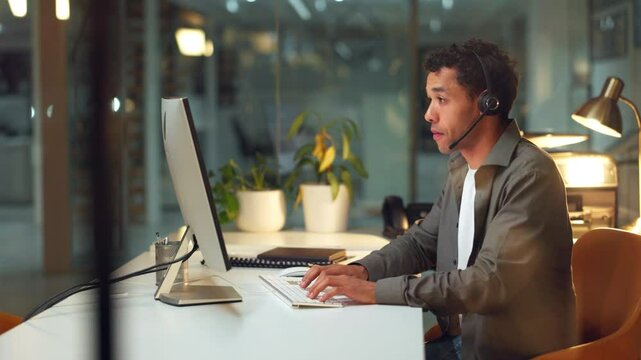 Businessman, office and computer with typing, email or communication as trader in investment bank. Male person, tech and microphone on stock market for economy as professional for company as advisory