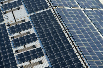 Obraz premium Aerial view of the roof covered with solar panels, at daytime