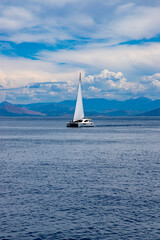 Naklejka premium A single yacht off the coast of Corfu, Greece in the summer