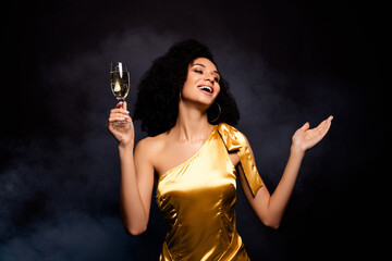 Photo of stunning adorable lady dressed gold outfit enjoying champagne isolated black color...