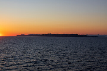 Naklejka premium Greek sunsets over the Aegean sea during summer 