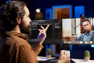 Engineer doing software debugging helped by BIPOC coworker in videocall meeting, checking errors in lines of code. IT worker fixing coding mistakes assisted by colleague in online teleconference