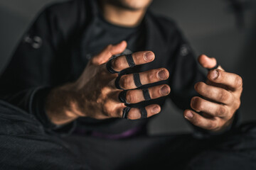 close up on hands of bjj brazilian jiu jistu fighter taped and ijured due training
