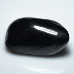 Polished Elegance: Shungite Gemstone on Pristine White Background