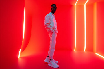 Men Sporting White High Top Sneakers with Solid Neon Red Accents, Captured in a Trendy Lifestyle Portrait