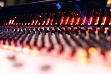 Control room panel board with switchers and levers to help with recording and editing audio files, buttons serve as mechanical and technical equipment in professional studio. Close up.
