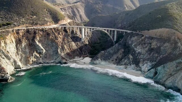 Aerial of the rugged coastline of Big Sur California. The Pacific Coast Highway and the famous Bixby Creek Bridge can be seen.