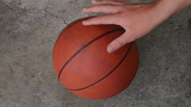 High angle view of man bouncing basketball ball on street floor