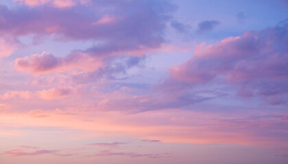 Pink and purple sunset sky with fluffy clouds, capturing the beauty of nature's colors and the serenity of twilight.