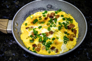 Traditional omelette with bacon and chives, real food, strong and nutritious protein
