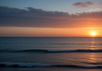 Obraz premium Sunset Over Calm Ocean Waves