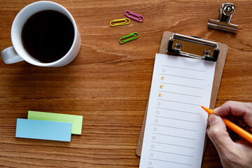 Coffee and checklist on the desk. As an eye-catching image for a business-related article.