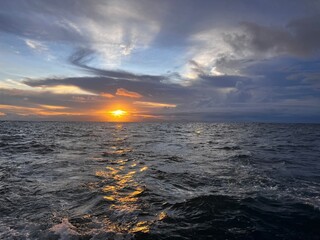 View of the wake behind a catamaran sailing through the Gulf of Nicoya off the coast of Costa Rica at sunset.