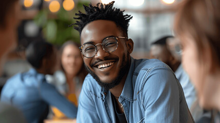 Fototapeta premium Cheerful Young Man With Glasses Smiling In Social Setting