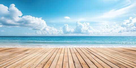 Fototapeta premium Wooden deck on tropical beach with blue sea and sky background. 
