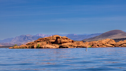 Sand Hollow Reservoir with red rock formations and a backdrop of nearby Sand Mountain. Near St...