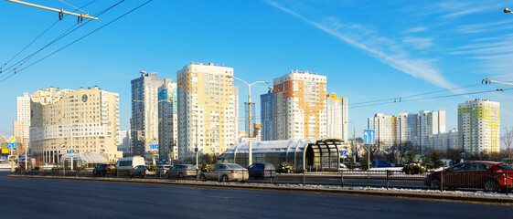 Naklejka premium Modern residential area Malinovka and cars on the wide street in the capital Minsk. Republic of Belarus