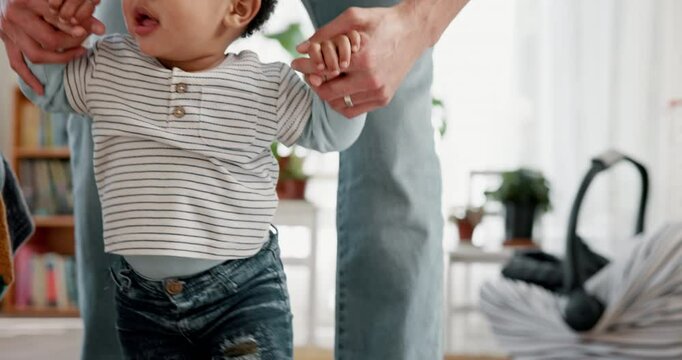 Hands, person and child walking in lounge for first steps with support, mobility development and learning balance. Father, baby and love with motor growth, helping and bonding for progress at house