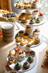 delicious dessert eclairs, Sweet cupcakes, Colorful macaroons, Bakery sweet, banquet table, holiday. Birthday, wedding, strawberry cake, donuts, tart, chocolate cake slice