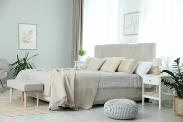 Big comfortable bed in room. Interior design