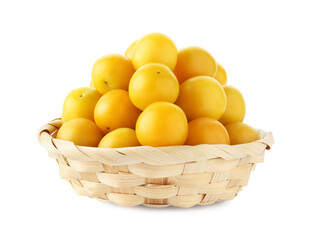 Fresh ripe yellow plums in wicker basket isolated on white