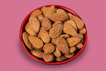 red pot with almonds isolated