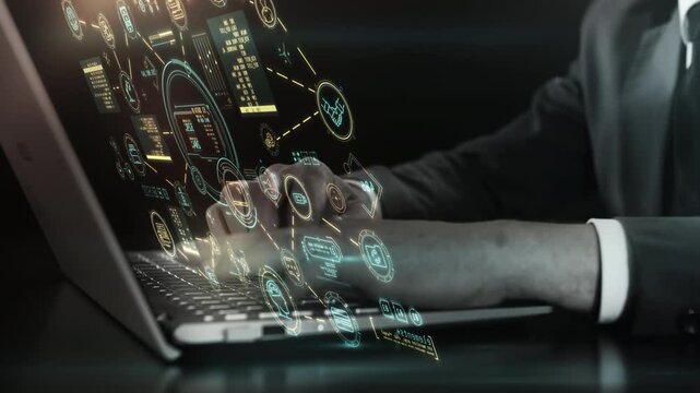 Conducting tasks on a laptop with an accompanying holographic screen.