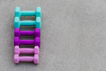 Weights lined up on cement with copy space