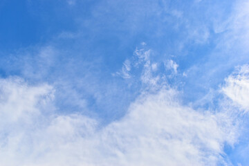 beautiful blue sky and white fluffy group of clouds with sunrise in the morning, natural background