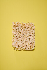 Isolated dried ramen noodles on yellow background