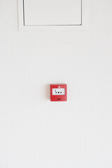 Red fire alarm button on wall ,