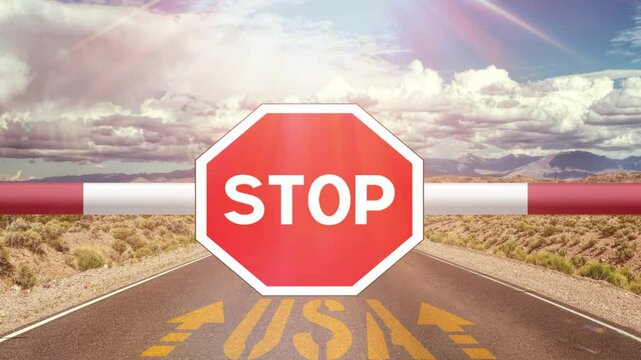 Stop sign and barrier at the border with the USA