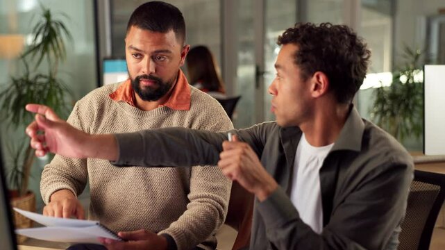 Business, men and web designer talking on computer in office for research, planning and ideas with manager. People, help or pointing for teamwork, brainstorming and feedback review of project update