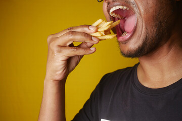 hungry man eating fries closeup