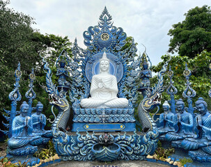 Fototapeta premium The famous Blue temple at Chiang Rai, Thailand, or Wat Rong Suea Ten in Thai. This temple hosts many Buddhist ornaments painted in all blue and gold colors.