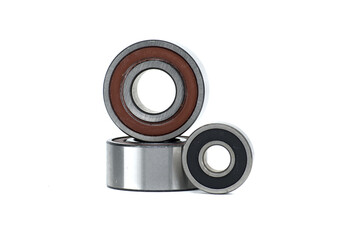 Close-up of three metal ball bearings of different sizes isolated on a white background
