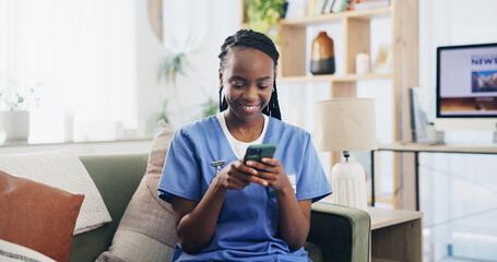 Black woman, nurse or phone on sofa for text, email or message for news update in home. Caregiver, mobile or smile in living room for healthcare information, chat or happy for medical breakthrough