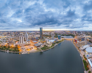 Yekaterinburg city and pond aerial panoramic view at summer or early autumn sunset. Night city in the early autumn or summer.