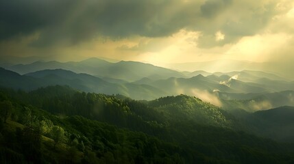 Fototapeta premium Sunbeams Shining Through Clouds Over Mountain Range