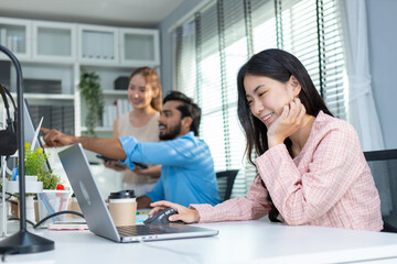 Happy young attractive asian businesswoman using laptop at office table. company employees sitting at work, Female accounting working towards marketing.