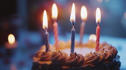 Birthday cake with lit candles, celebrating a special occasion.