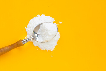 Baking soda on yellow background.