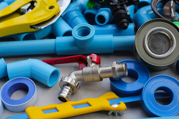 Plumber equipment with blue pvc pipe connections for plumbing work.