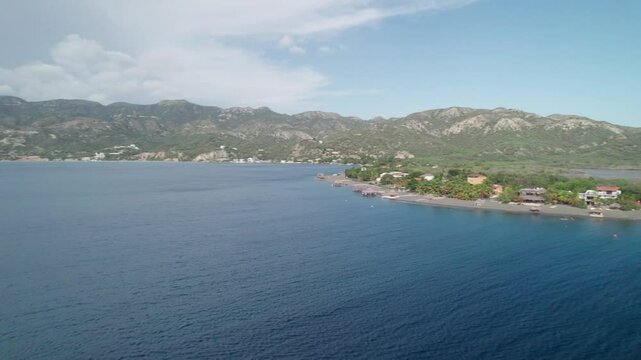 Aerial Pan over Palmar de Ocoa Coastal Town and Beach, Azua, Dominican Republic
