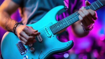 Obraz premium Under colorful stage lights, a guitarist expertly plays a turquoise electric guitar, captivating the audience with his dynamic performance during a live music event