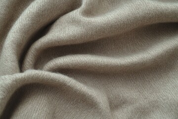 Close-Up Macro Shot of Beige Wool Fabric with Fine Texture and Subtle Stitching