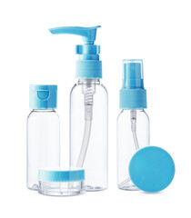 Clear plastic bottles with blue pumps and spray tops arranged on a white background